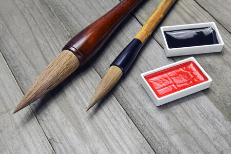asian writing brushes and ink for calligraphy on woodの写真素材