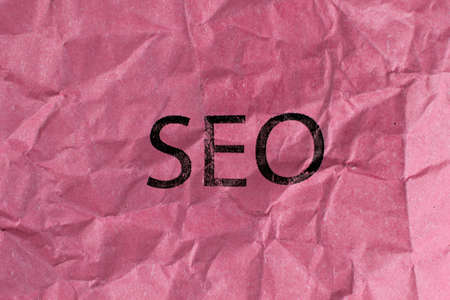 concept of SEO word on blue crumpled paperの写真素材