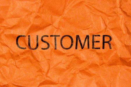 word customer on orange paperの写真素材