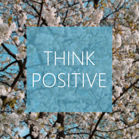 Think Positive concept, spring blooming tree in the background