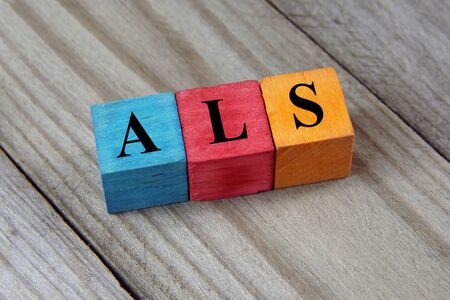 ALS Amyotrophic Lateral Sclerosis acronym on colorful wooden cubesの写真素材