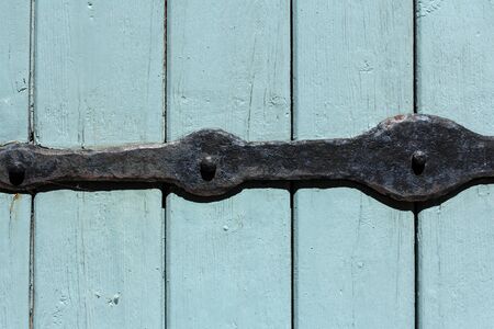 old decorative metal and blue wooden doorの写真素材