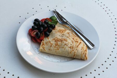 pancakes with tomatoes, olives and mozzarella cheese