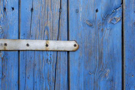 closeup of blue wooden boards and metal hinge rutsyの写真素材