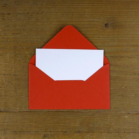 open red envelope on wooden background