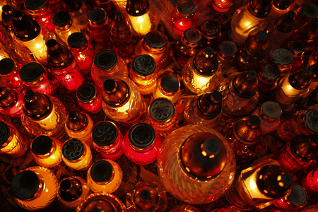 closeup of burning candles at the cemetery on All Saints' Dayの写真素材