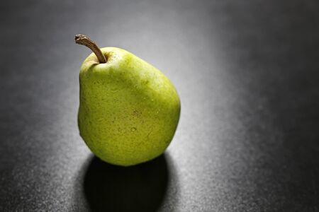 pear with water drops on black backgroundの写真素材