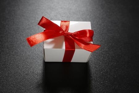 gift with red ribbon on black background (Valentine's gift)の写真素材