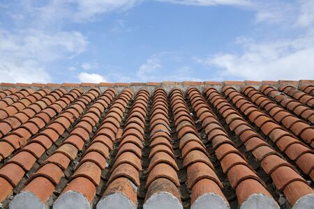 old roof tiles against blue sky
