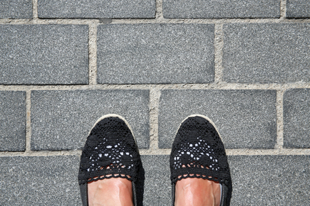 selfie suntanned female feet on granite pavementの写真素材