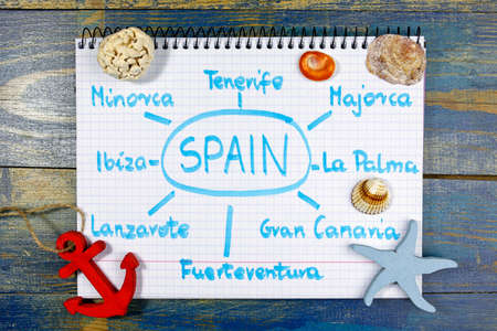 Most popular spanish islands for summer vacations. Written in notebook with sea theme decorationsの写真素材