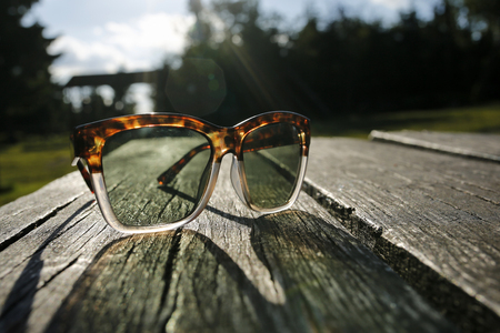 Fashionable sunglass on wooden boardの写真素材