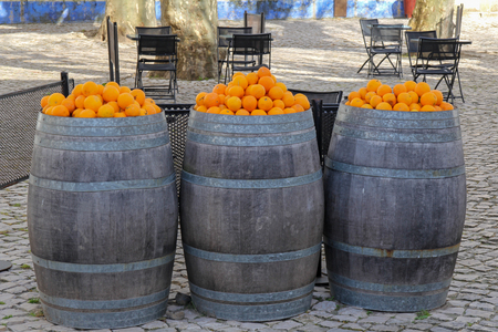 Heap of oranges on the top of barrelsの写真素材