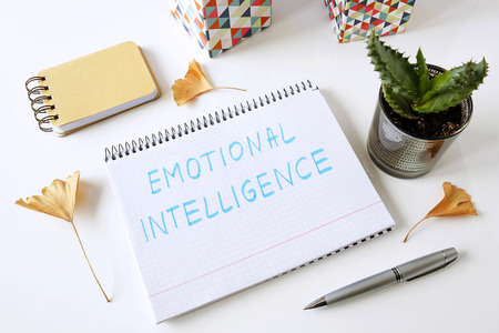 emotional intelligence written on a notebook on a white tableの写真素材