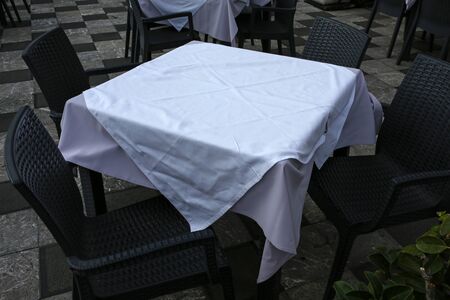 outdoor restaurant, empty table with white tablecloth