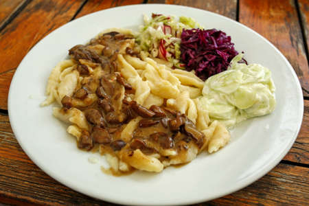 vegetarian meal, homemade noodles with mushroom saucea and fresh saladsの写真素材