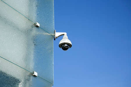security CCTV camera on modern glass building