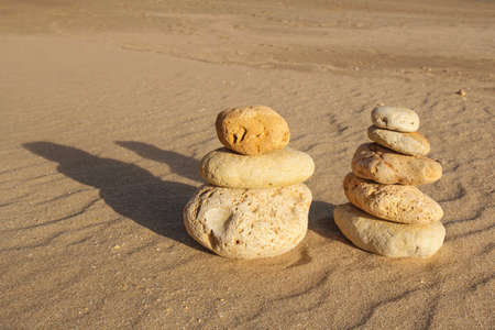 pile of pebbles on a sandy beach, balance, zen conceptの写真素材
