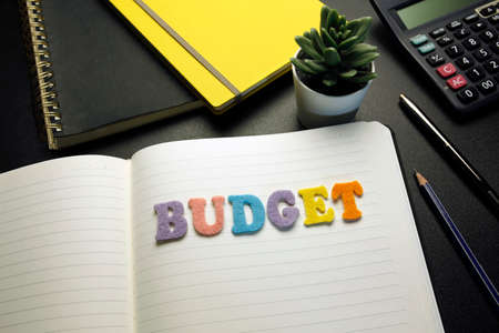budget word made with colorful felt letters on open notebookの写真素材