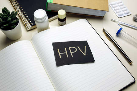 HPV (Human Papillomavirus) written on open notebookの写真素材