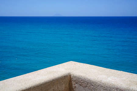 turquoise Tyrrhenian Sea and Stromboli volcanic island seen from the viewpoint of Sanctuary of Santa Maria dell'Isola in Tropea, Calabria, Italyの写真素材