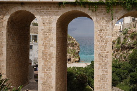 bridge next to Lama Monachile spectacular beach in Polignano a Mare, Apulia, Italyの写真素材
