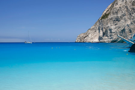 turquoise water seen from the Navagio beach with high cliffs, touristic famous landmark on Zakynthos...