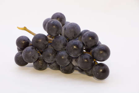 bunch of black grapes on a white background