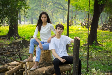 Portrait of young asian teens with casual wear sit in the parkの写真素材