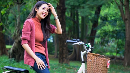 young woman enjoy ride bicycles in the parkの写真素材