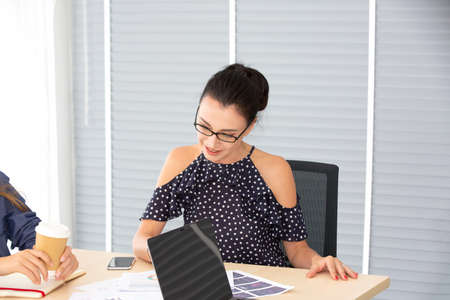 Business people working in office on desktop computer, Portrait of confidence business women in the...