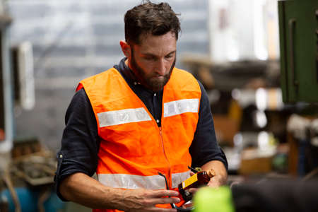 A portrait of an industrial man and woman engineer with tablet in a factory, working.の写真素材