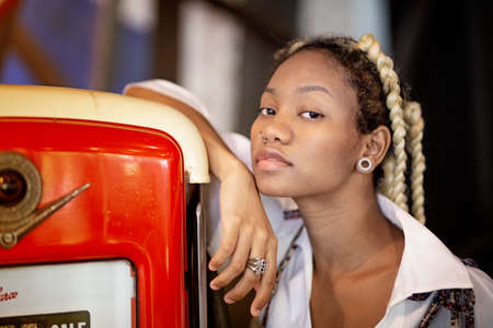 Portrait of Afro young women sitting by window and look awayの写真素材