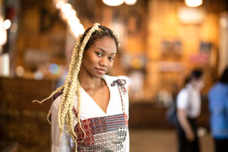 Portrait of Afro young women sitting by window and look awayの写真素材