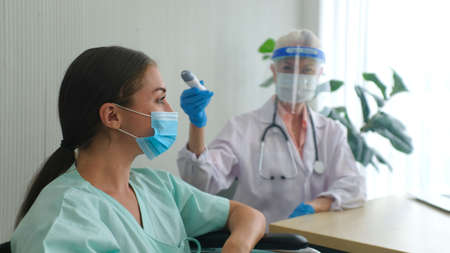 Coronavirus protection during the quarantine, Female doctor doing medical exam to a women patient.の写真素材