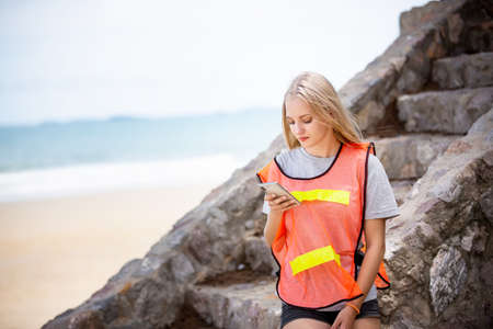Green volunteering. Optimistic volunteers holding garbage bag and help picking up trash at park,...
