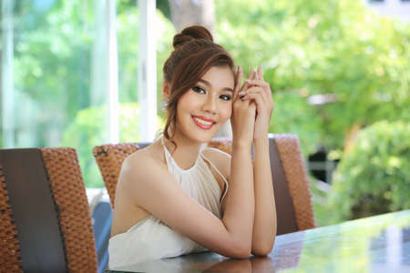 Head shot of beautiful attractive smiling woman in white wedding dress with bridal hair curl hairstyle.の写真素材