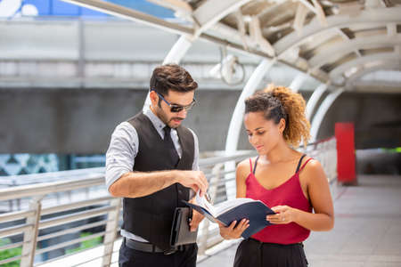 businessman and colleague  looking at a Notebook and Discussing new marketing strategy