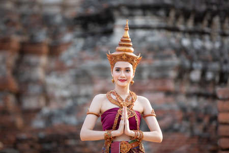 Asia woman wearing traditional Thai dress,The costume of the national dress of ancient Thailand against temple.の写真素材