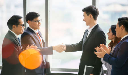 Business people shaking hands in the modern office finishing successful meetingの写真素材