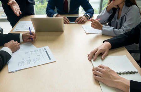 young business team working together at office. Manager pointing at a chart and explaining the...