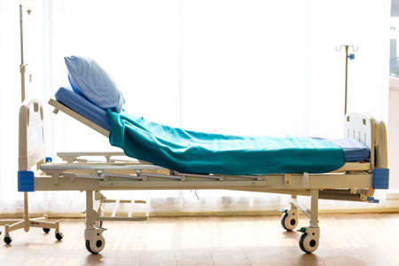 Patient bed in hospital ward with no bodyの写真素材