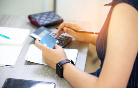 Closeup shot of an unrecognisable businesswoman analysing graphs on Graph Papers On Table and business people writing on paperworkの写真素材