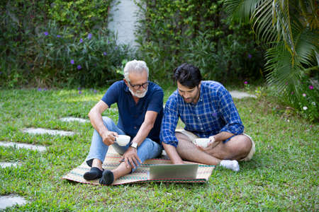 Hipster man taking care about his elderly father in house.