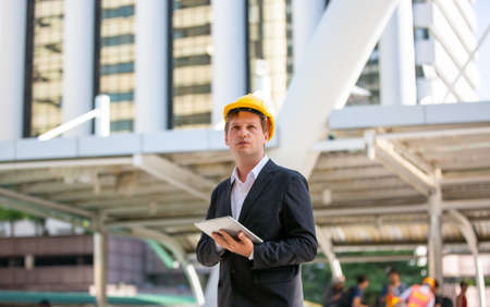 Construction engineers discussion with architects at construction site or building site of high-rise...