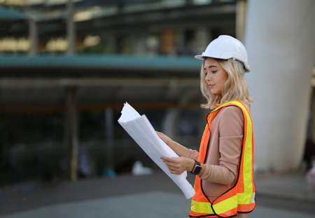 Construction engineers discussion with architects at construction site or building site of high-rise...