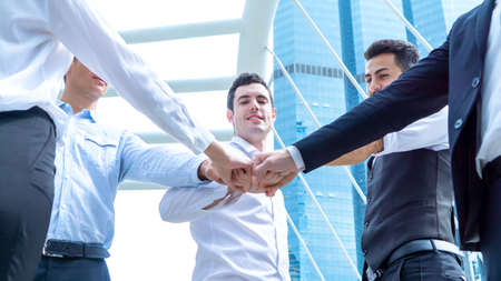 Diverse business people group put hands together in stack pile at training as concept of sales team corporate unity connection, teambuilding loyalty, support in teamwork, coaching, close upの写真素材