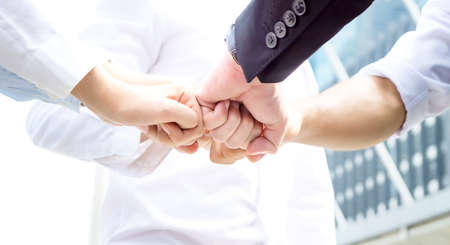 Diverse business people group put hands together in stack pile at training as concept of. Business people shaking hands, finishing up a papers signing. Meeting, contract and lawyer consulting concept.の写真素材