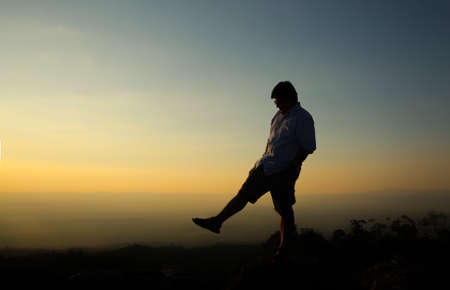a man on a mountain top. Person on the rock. Sport and active life concept. Beauty world.の写真素材