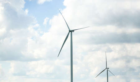 clean energy power concept, wind turbine and cloud sky.